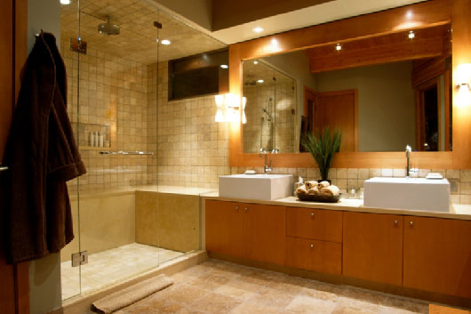 bathroom with glass-enclosed shower, dual vanity, and recessed lighting.