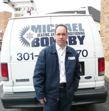 Michael Bonsby plumber standing in front of a service truck.
