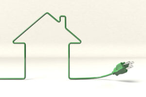 Green electrical cord bent in the shape of a house, on white background. Green plug to the right of the house shape.